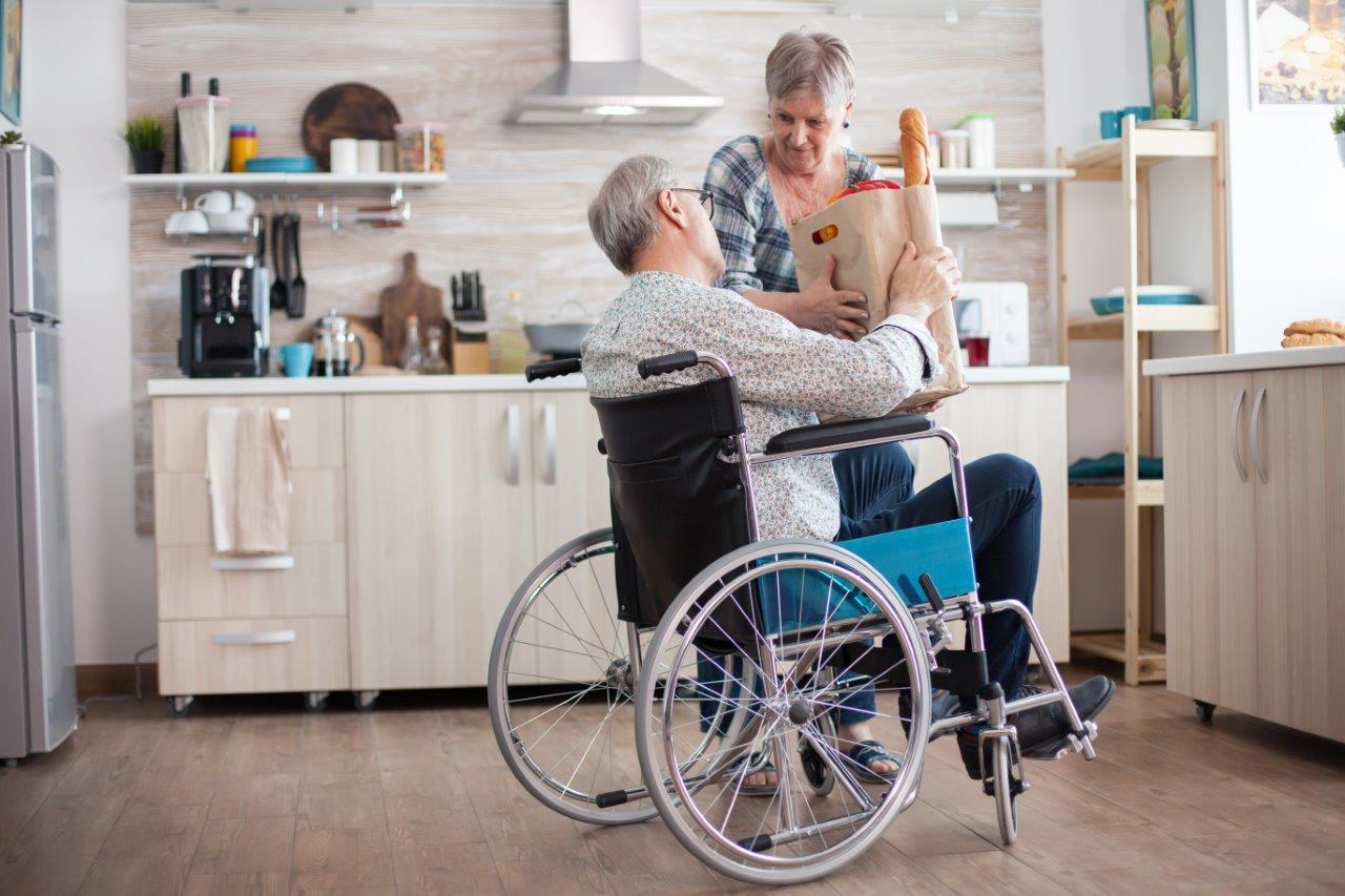A person supporting a wheelchair user